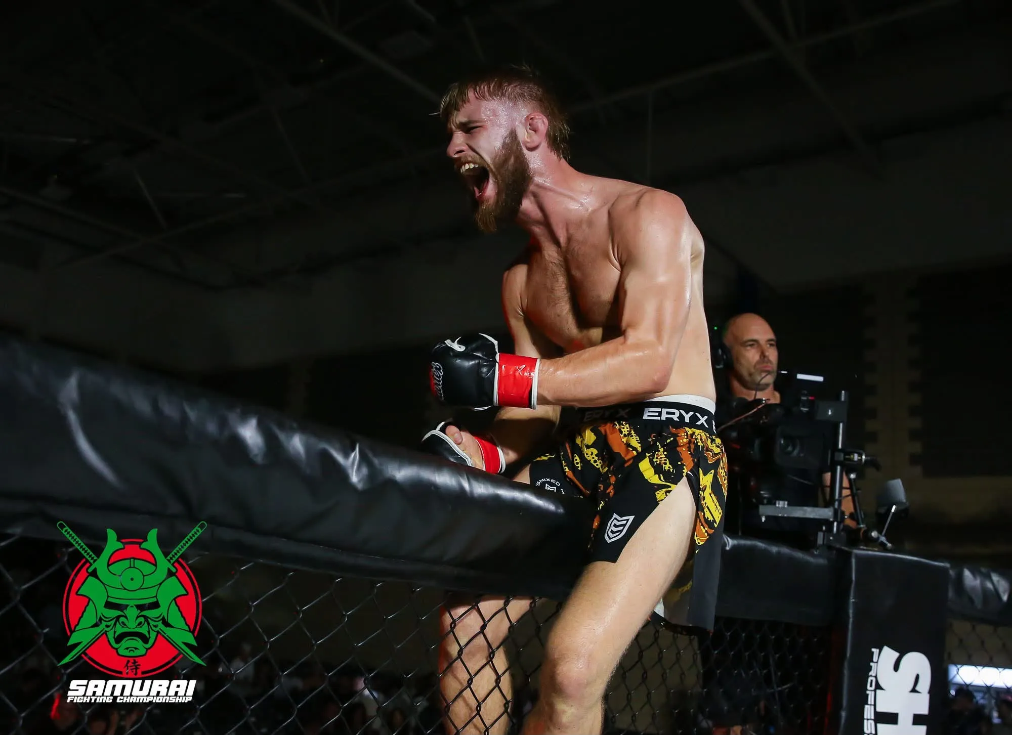 Matthew Waters roaring in celebration against the cage after a fight
