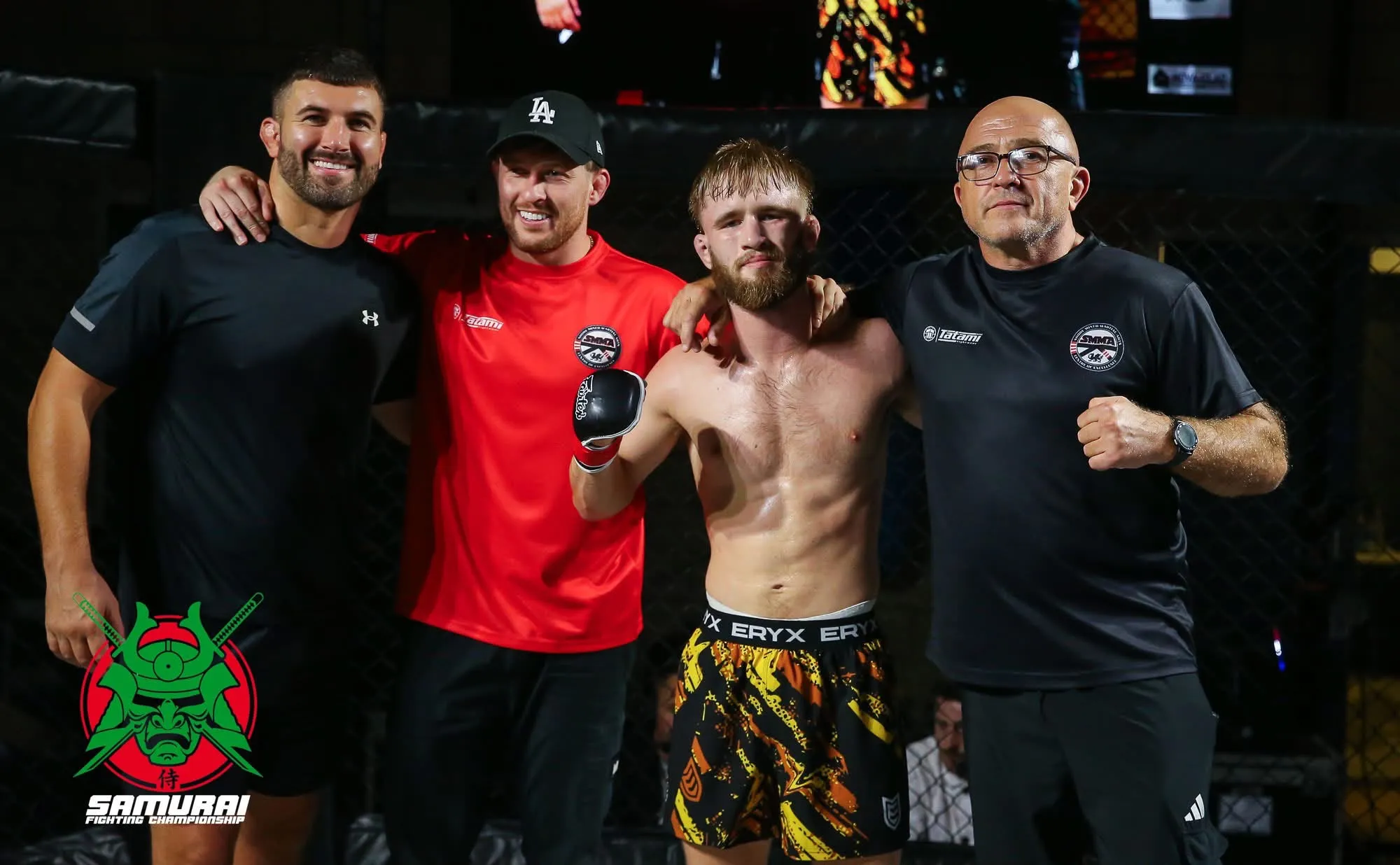 Matthew Waters in the cage with his coaches after a win
